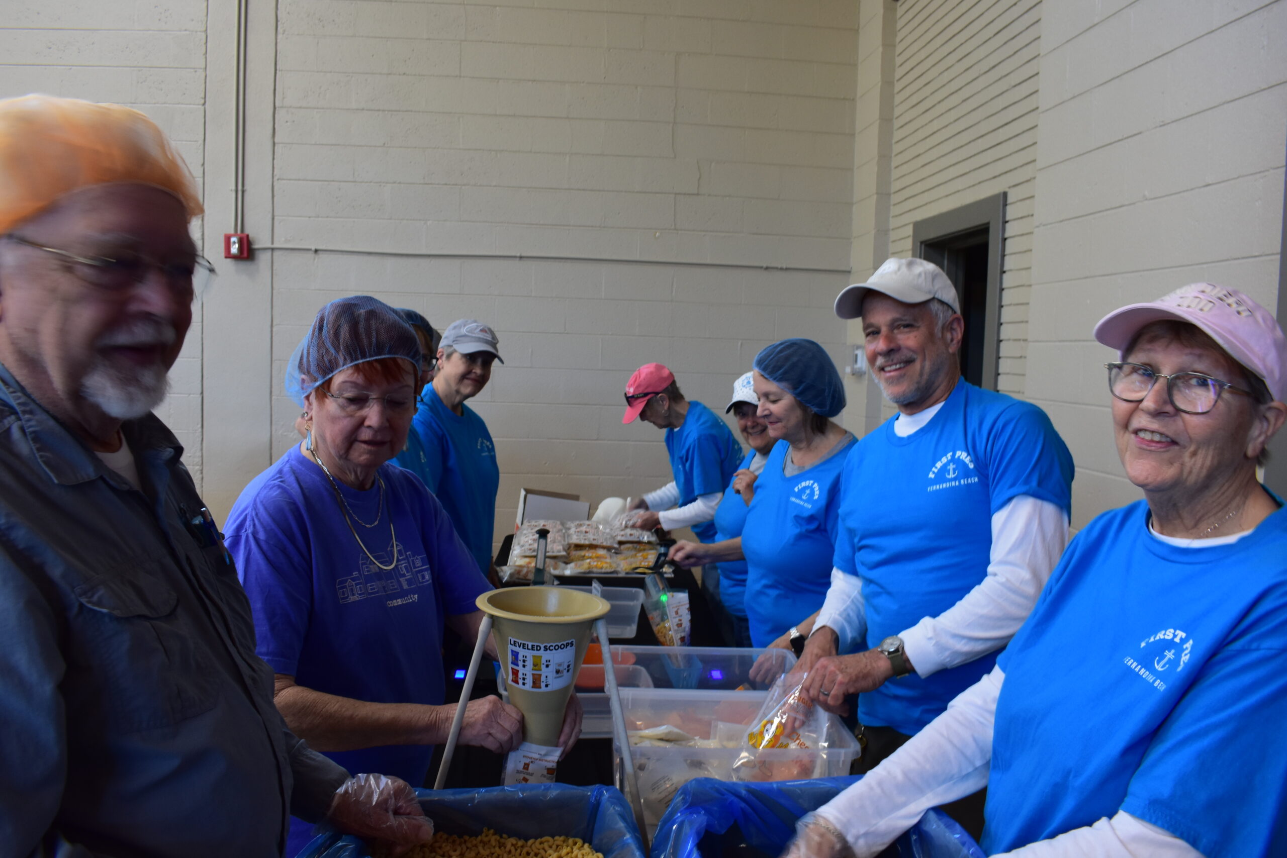 Hundreds gather at rec center to pack meals for Hunger Fight Members of First Presbyterian Church pack in the assembly line. Photo by Kate Kimmel/Nassau NewsLine