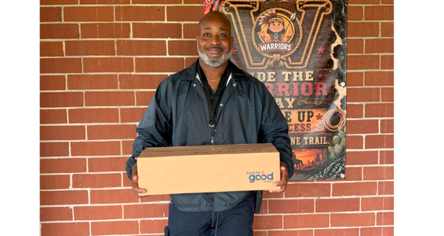 Officer Caldwell prepares to deliver food. Photo courtesy Nassau County School District